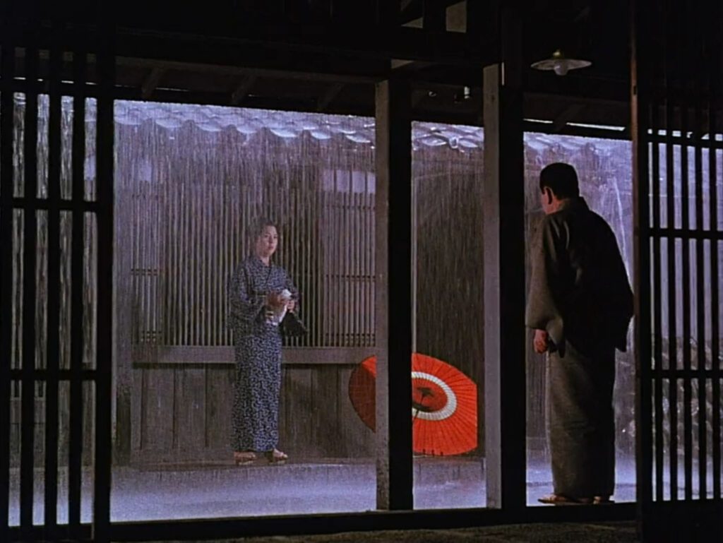 Floating Weeds - Yasujiro Ozu - Machiko Kyo - Ganjiro Nakamura - Sumiko - Komajuro - rain - red umbrella - wooden columns